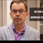 Jason Reid standing in a hallway with the words "Fear of Workplace Change"